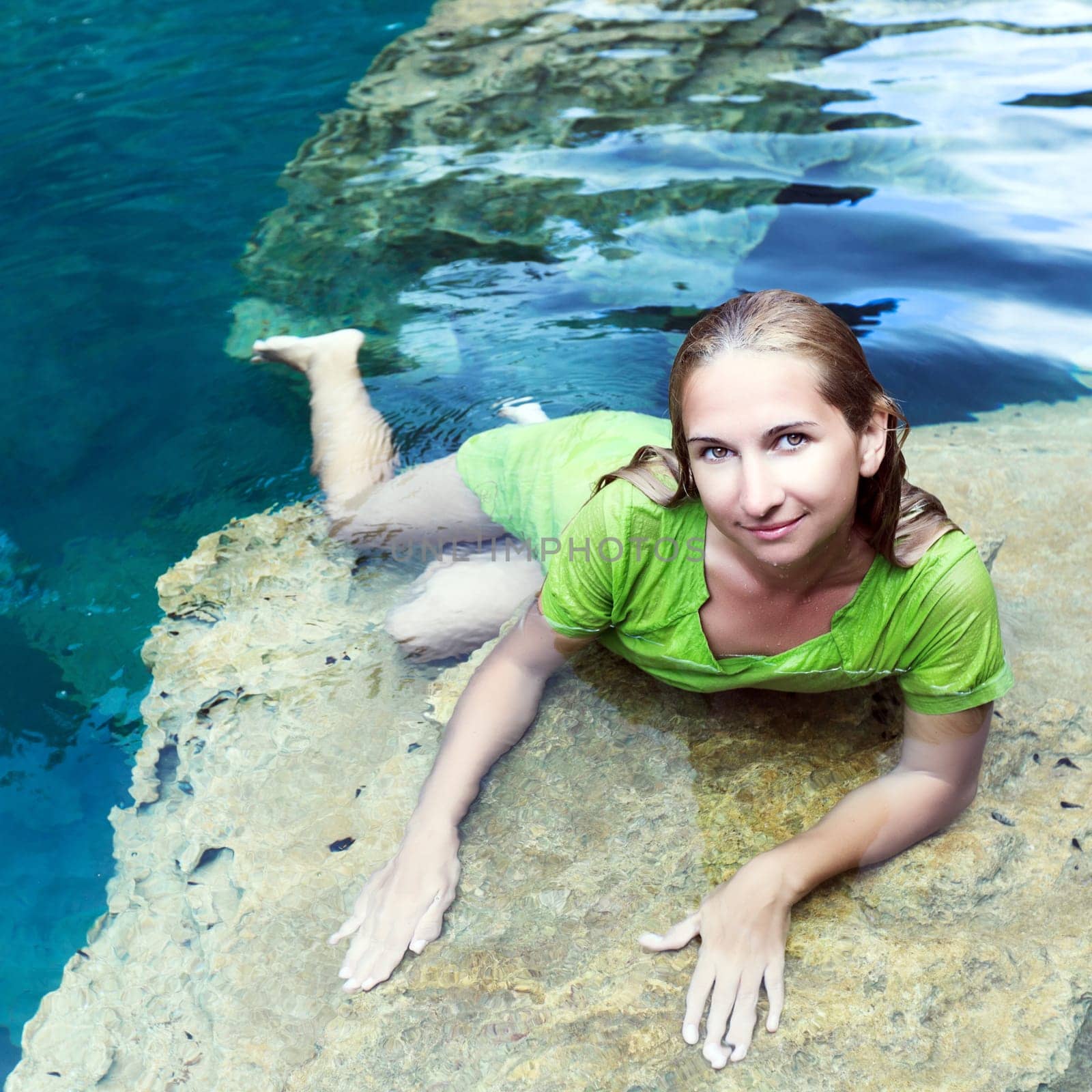 Woman like mermaid in wet dress in lake