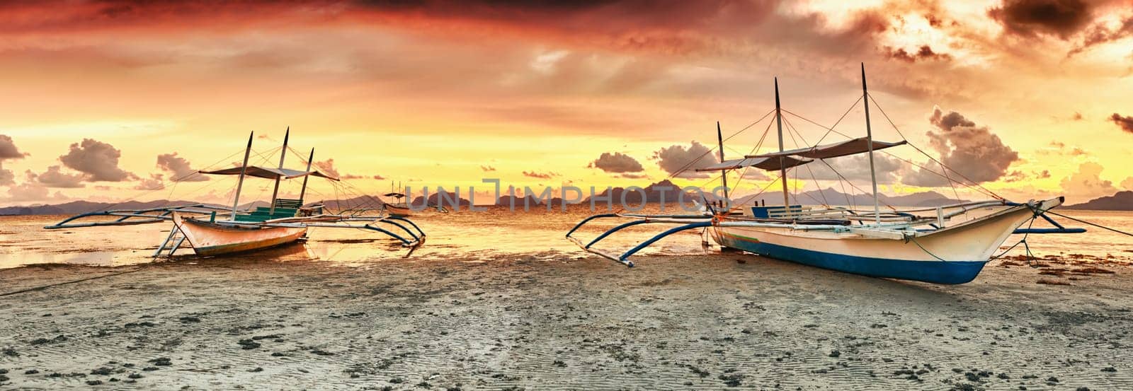 Traditional philippine boats bangka at sunset time