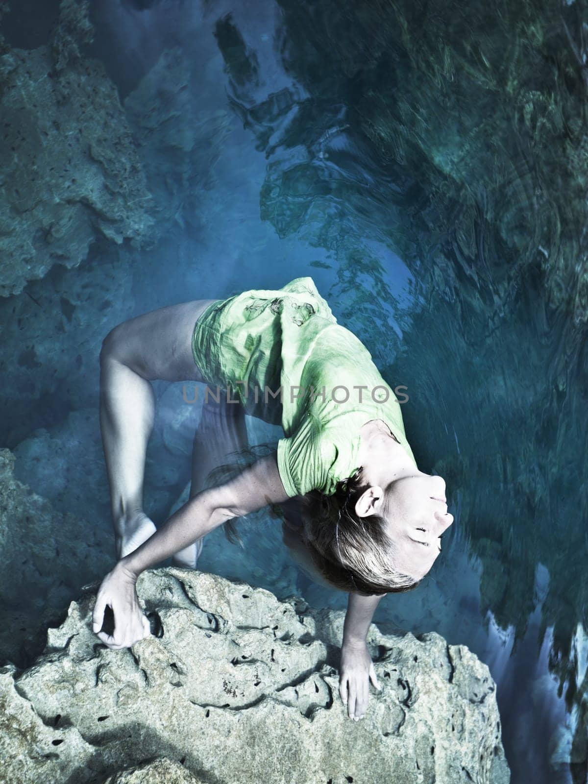 Woman like mermaid in wet dress in lake