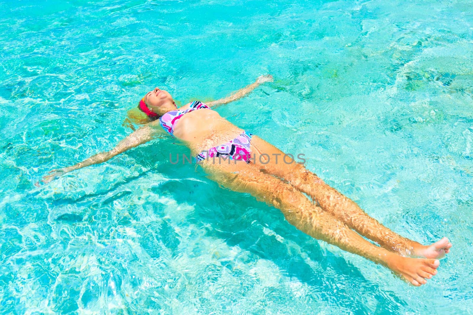 Beautiful woman relaxing on the water surface