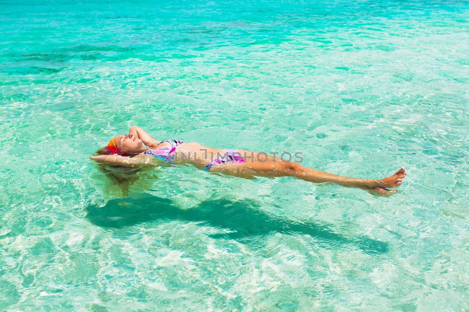 Beautiful woman relaxing on the water surface