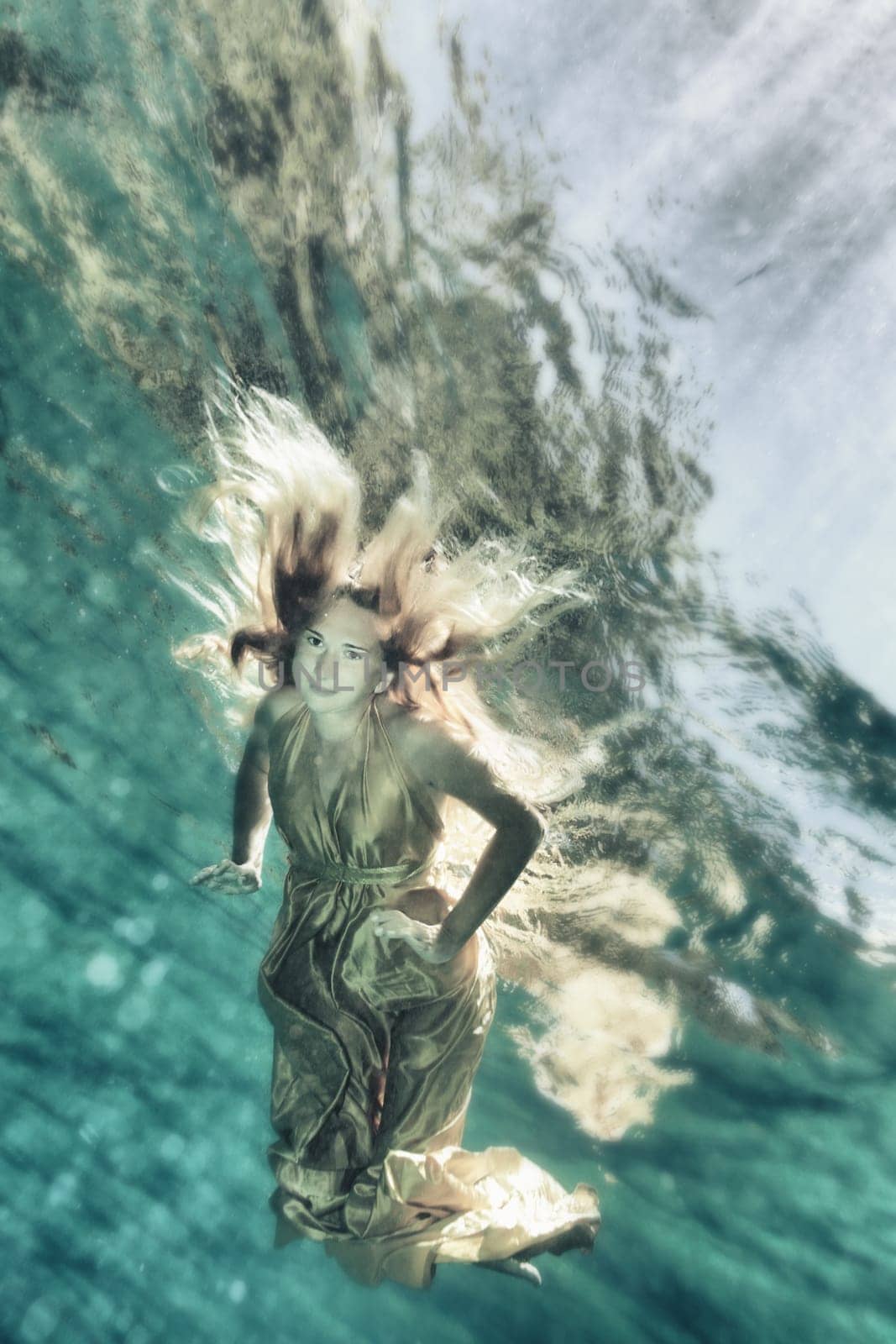 Fashion beautiful woman underwater like a mermaid