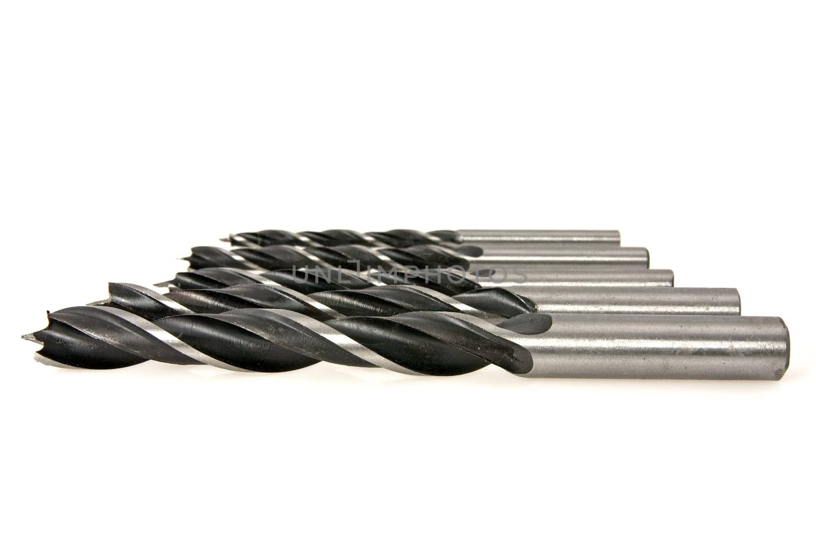 set of metal drill bits on white background