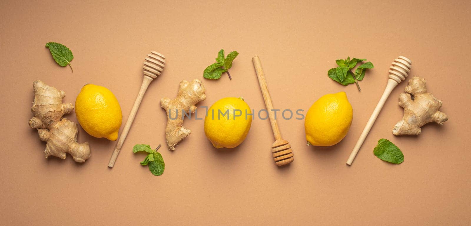 Composition with lemons, mint, ginger top view on simple beige background. Food for immunity stimulation and against seasonal flu. Healthy natural remedies to boost immune system.