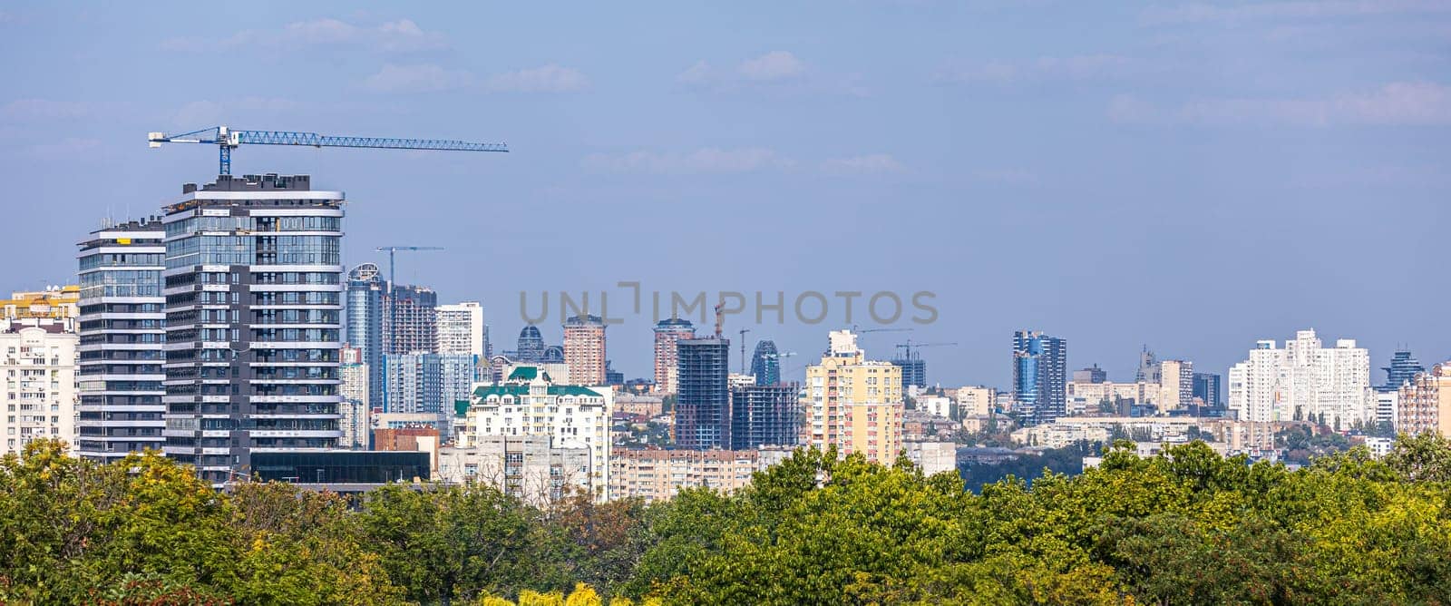 Aerial photography of residential areas of Kyiv with a view of the railway station and new skyscrapers under construction, aerial view, city photography. Copy space.
