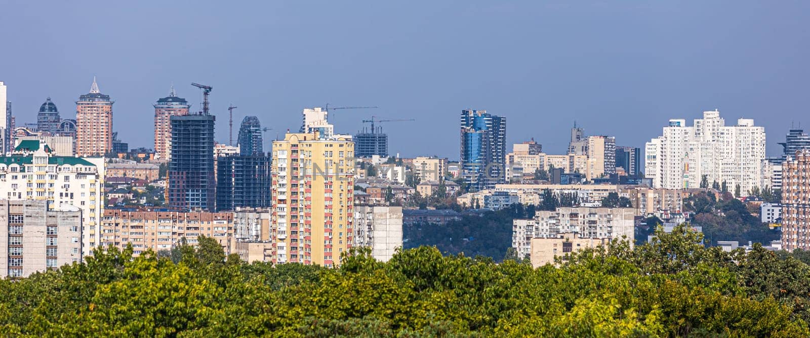 Aerial photography of residential areas of Kyiv with a view of the railway station and new skyscrapers under construction, aerial view, city photography. Copy space.