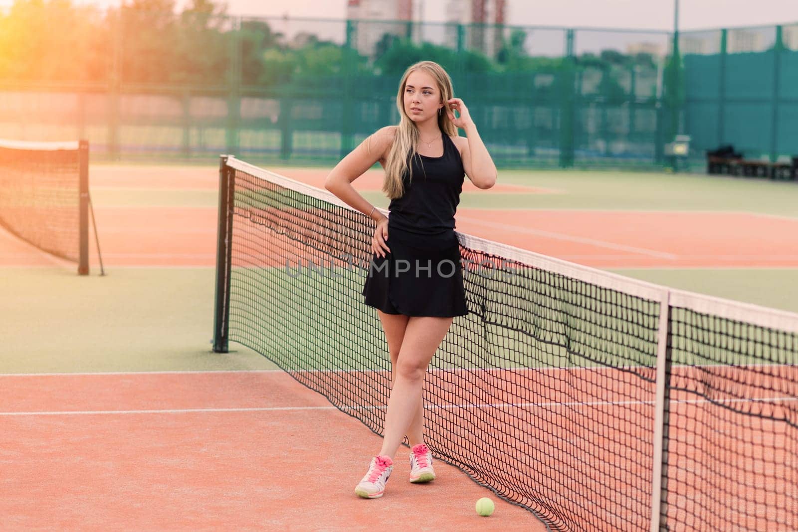 Tennis tournament. Female player at clay tennis court