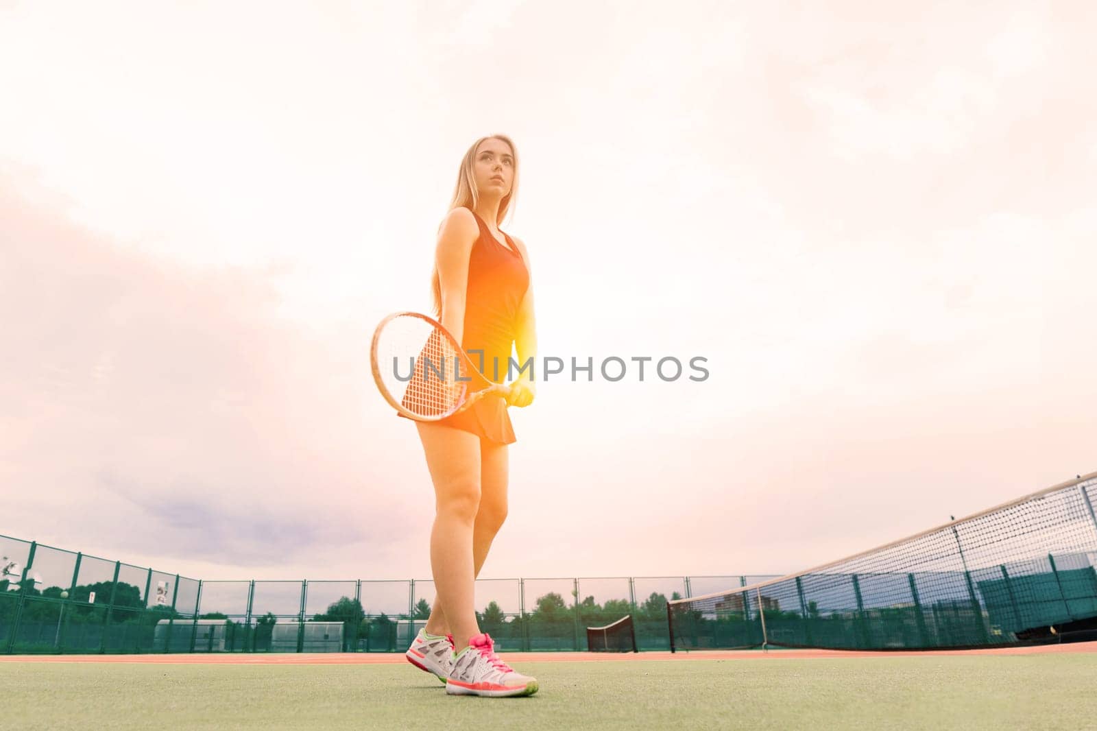 Tennis tournament. Female player at clay tennis court