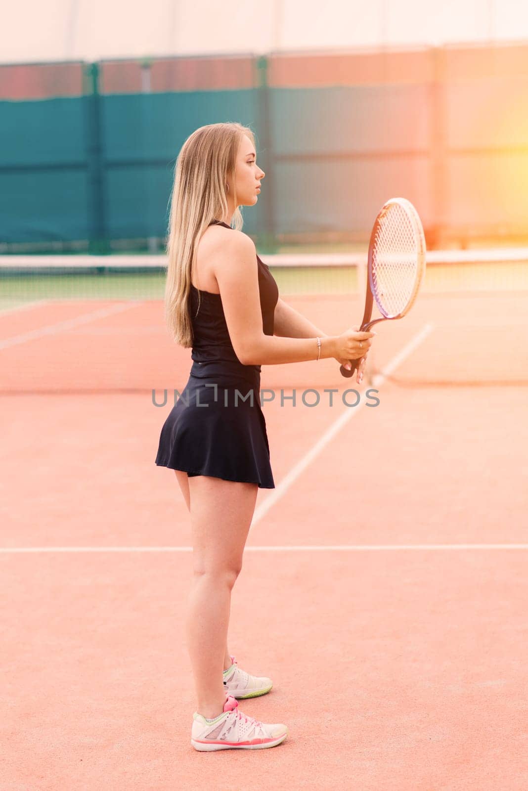 Tennis tournament. Female player at clay tennis court