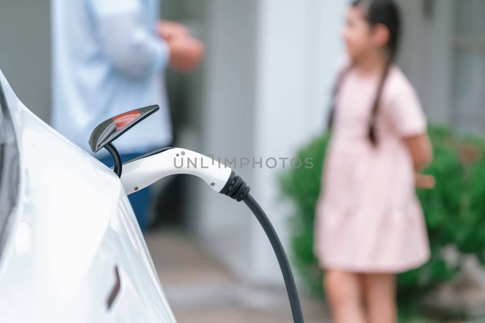 Focused electric vehicle recharging battery by home charging station. Synchronos by biancoblue