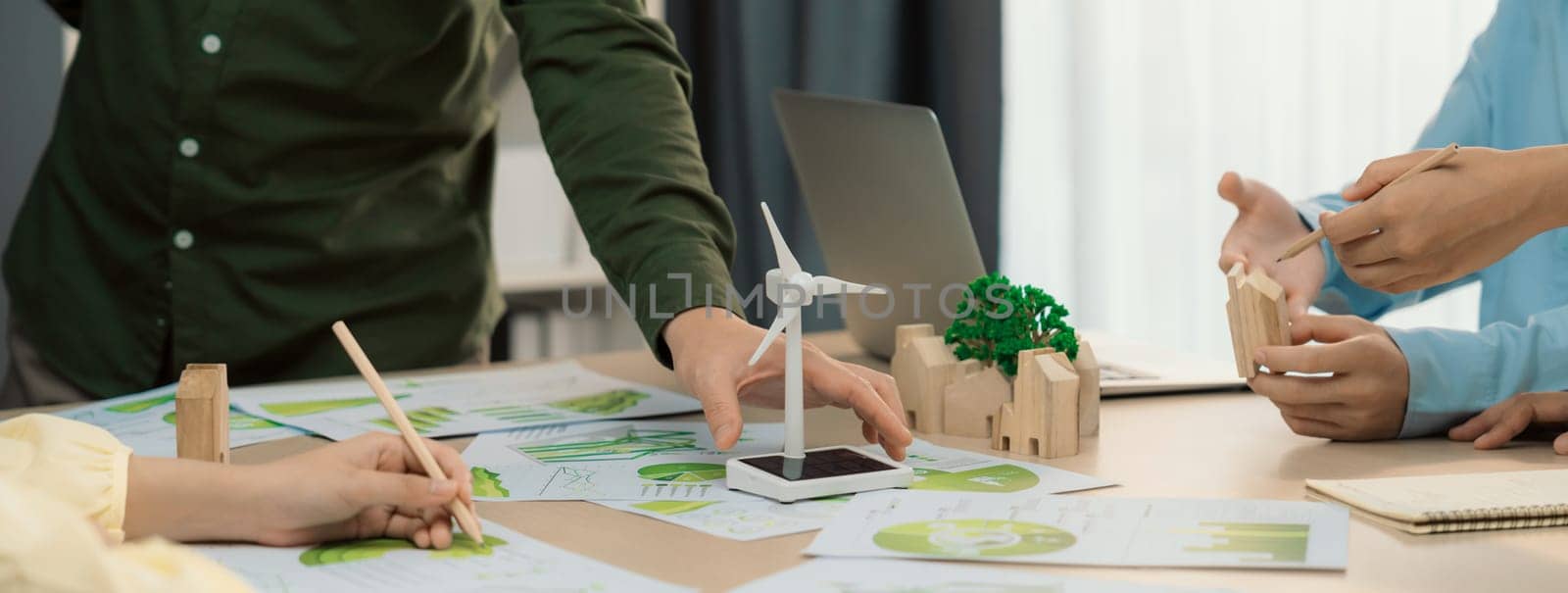 Windmill model placed on green business meeting table. Front view. Delineation. by biancoblue