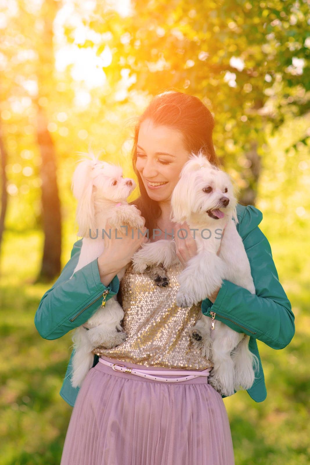 Young woman with her dog. Puppy white dog is running with it's owner. Concept about friendship and animal.