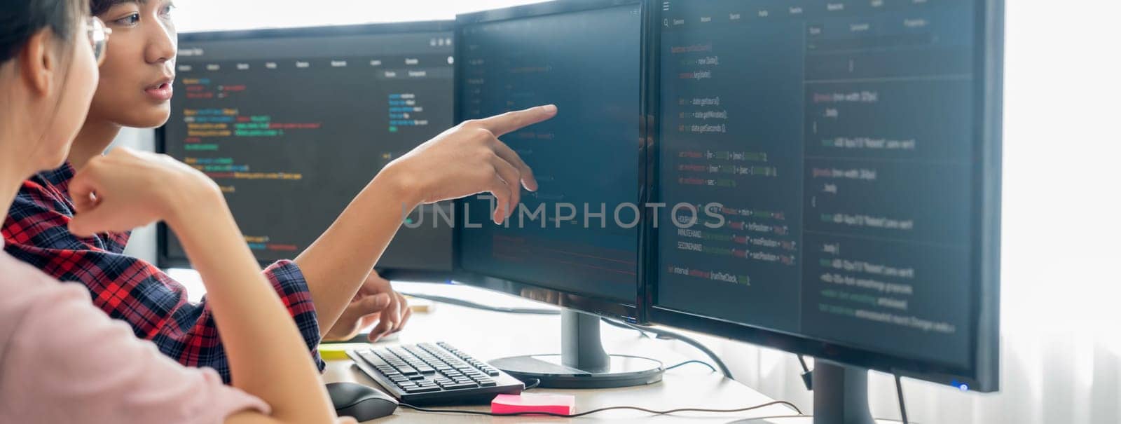 Cropped image of professional programer team collaboration discuss about web coding while coworker point java script displayed on computer at modern company office. Closeup. Burgeoning.