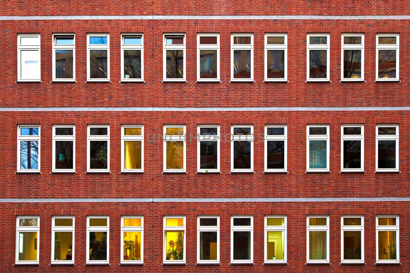 facade of office building in the evening with illuminated windows