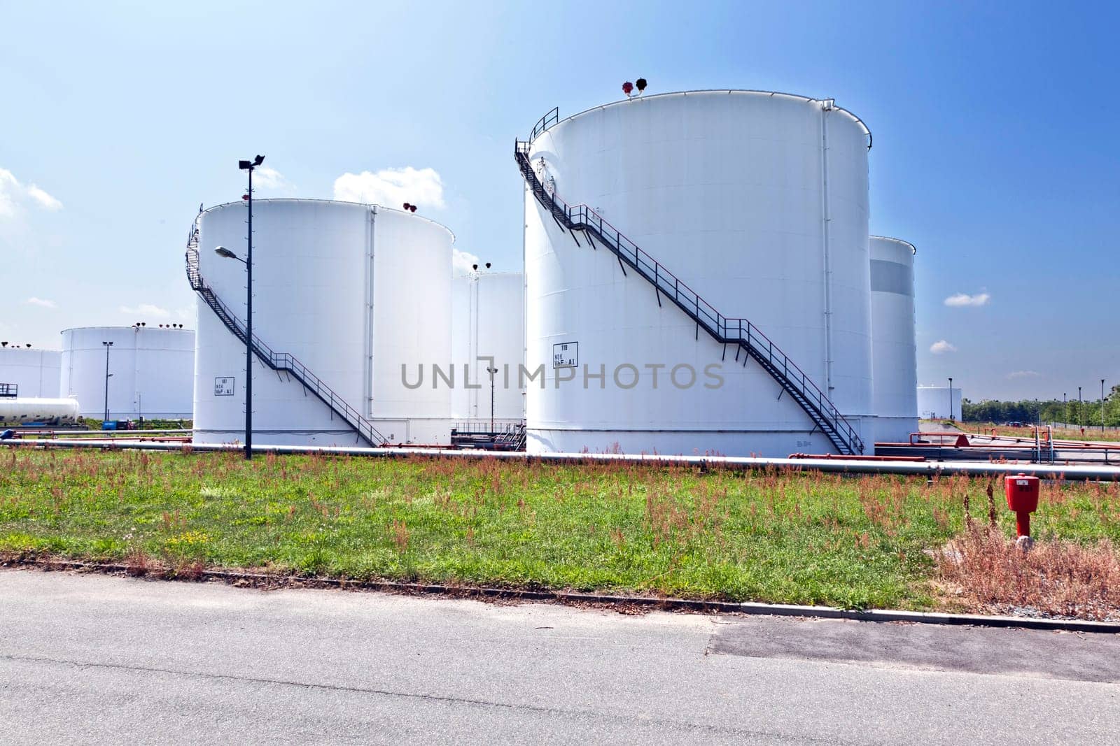 Big white industrial tank with blue sky
