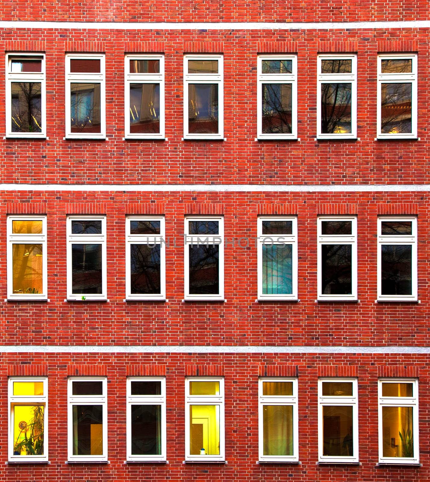 facade of office building in the evening with illuminated windows