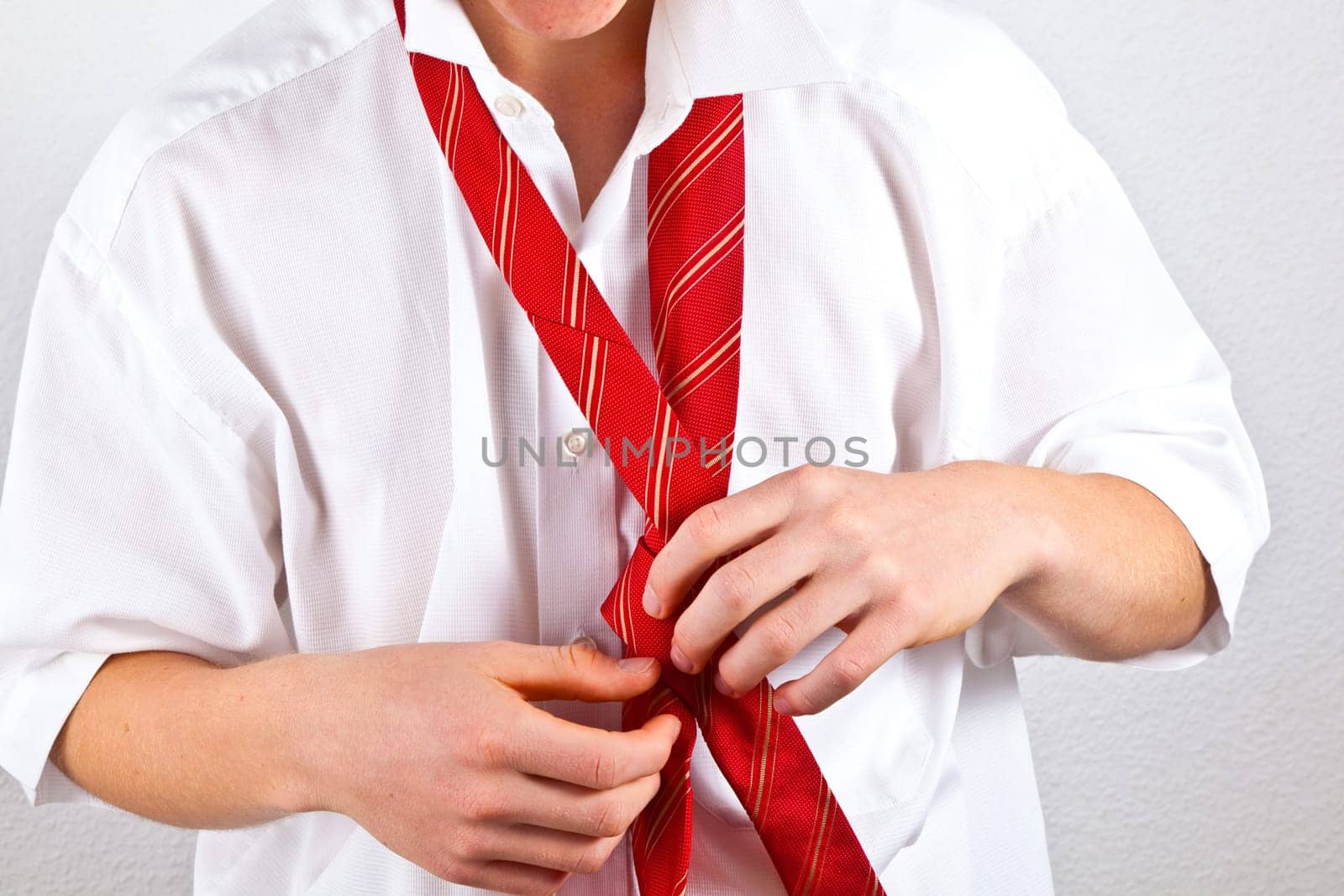 attractive man binding his tie