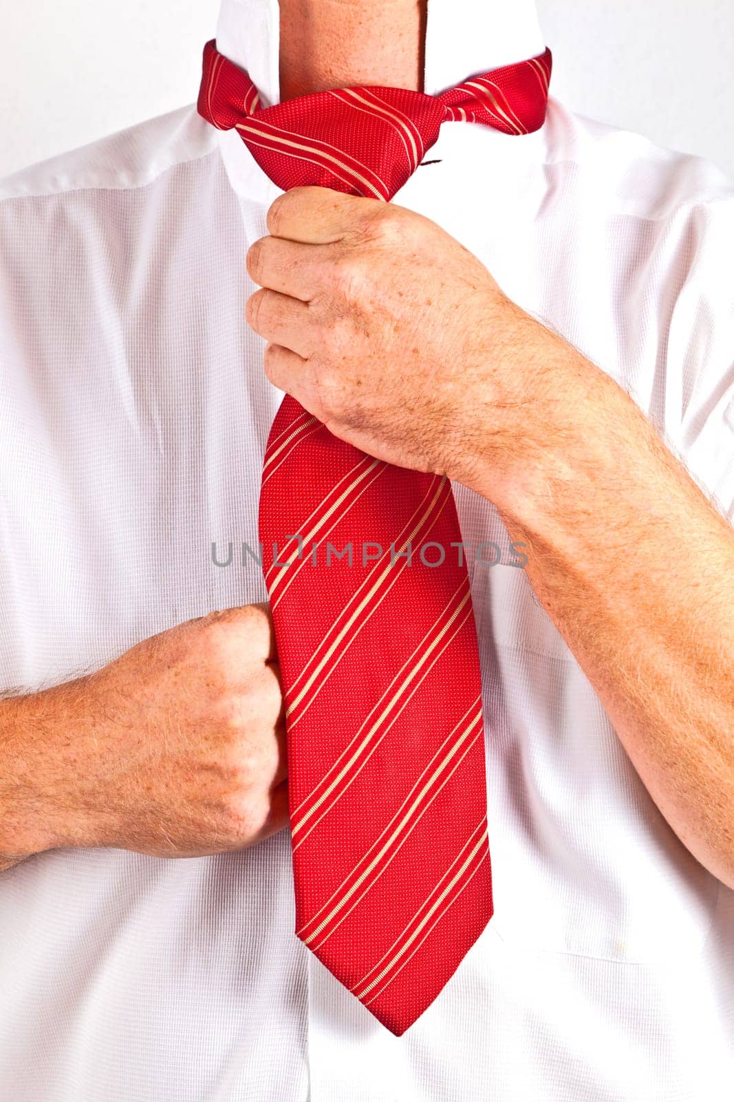 attractive man binding his tie