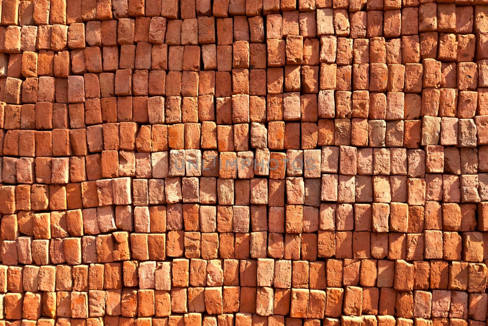 red stapled bricks give a harmonic pattern in the sun