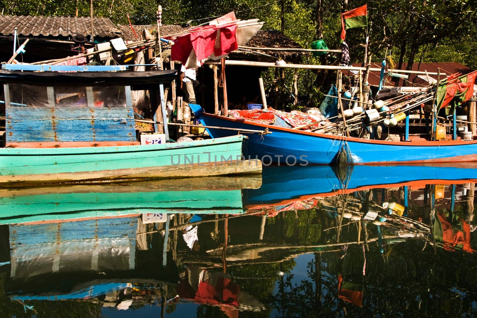 huts and colorful  fisherboats at the mangrove everglades in a small fishermans village in Koh Chang