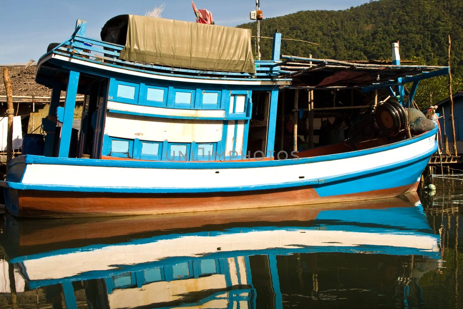 huts and colorful  fisherboats at the mangrove everglades in a small fishermans village in Koh Chang