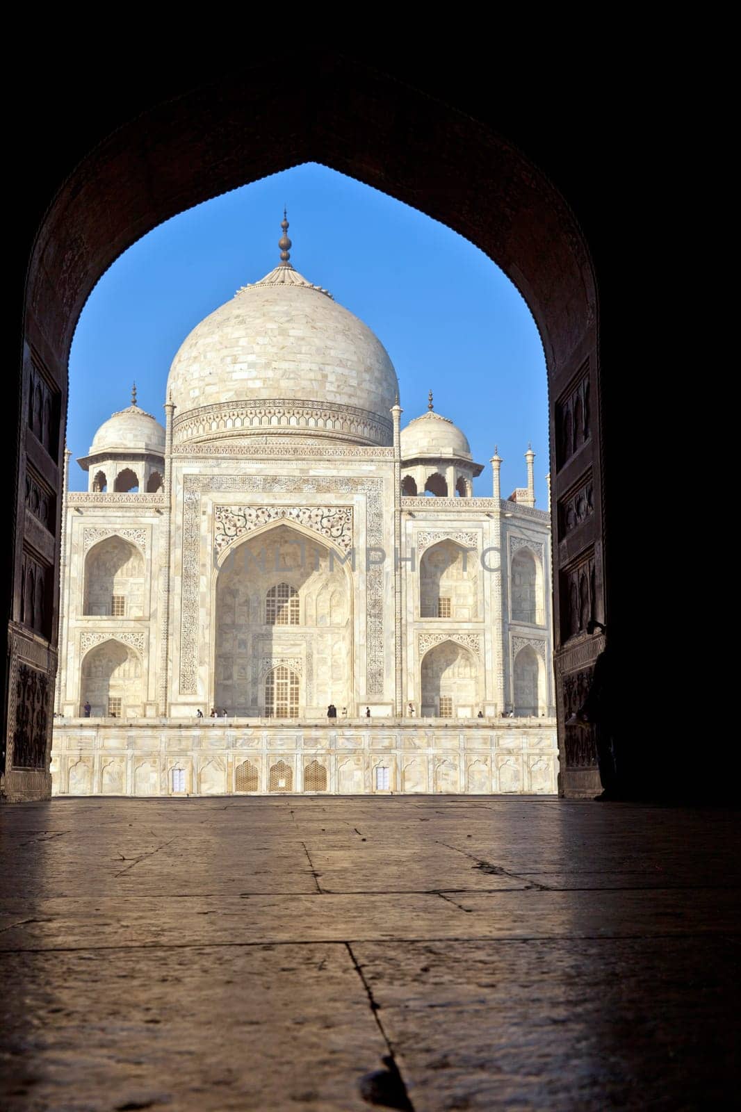 Taj Mahal in India in an arch of the entrance gate