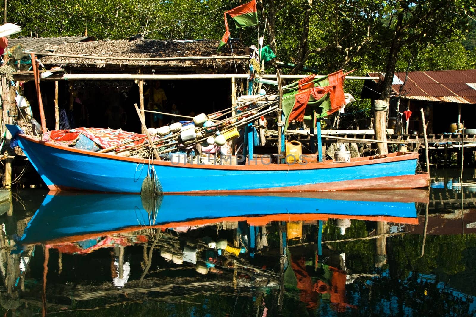 huts and colorful  fisherboats at the mangrove everglades in a small fishermans village in Koh Chang