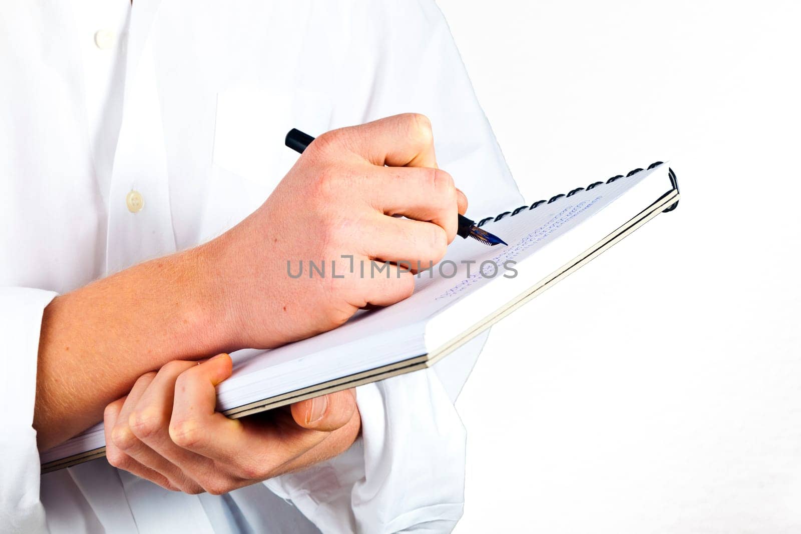 man writing in a book
