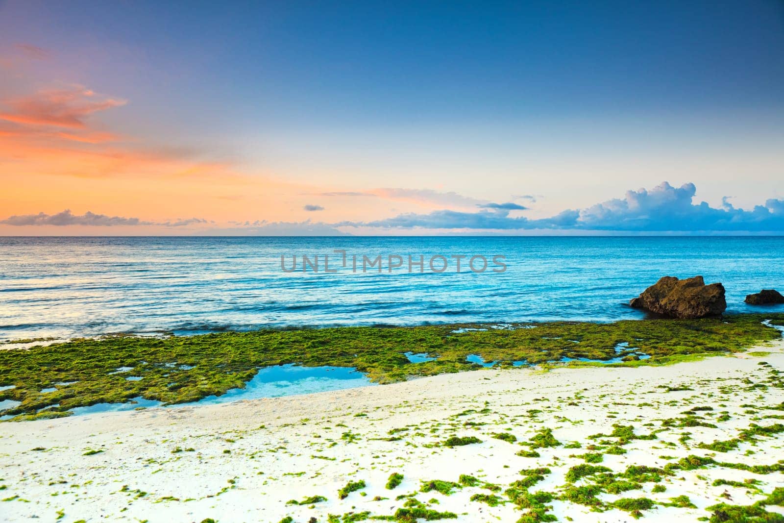Sunrise over the sea. Stone on the foreground
