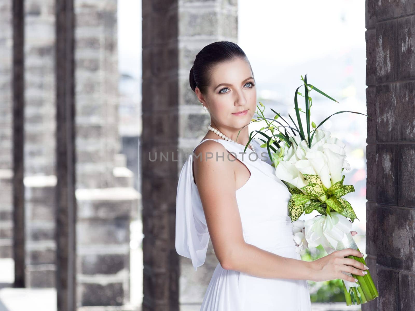 Beautiful bride with a wedding bouquet outdoor