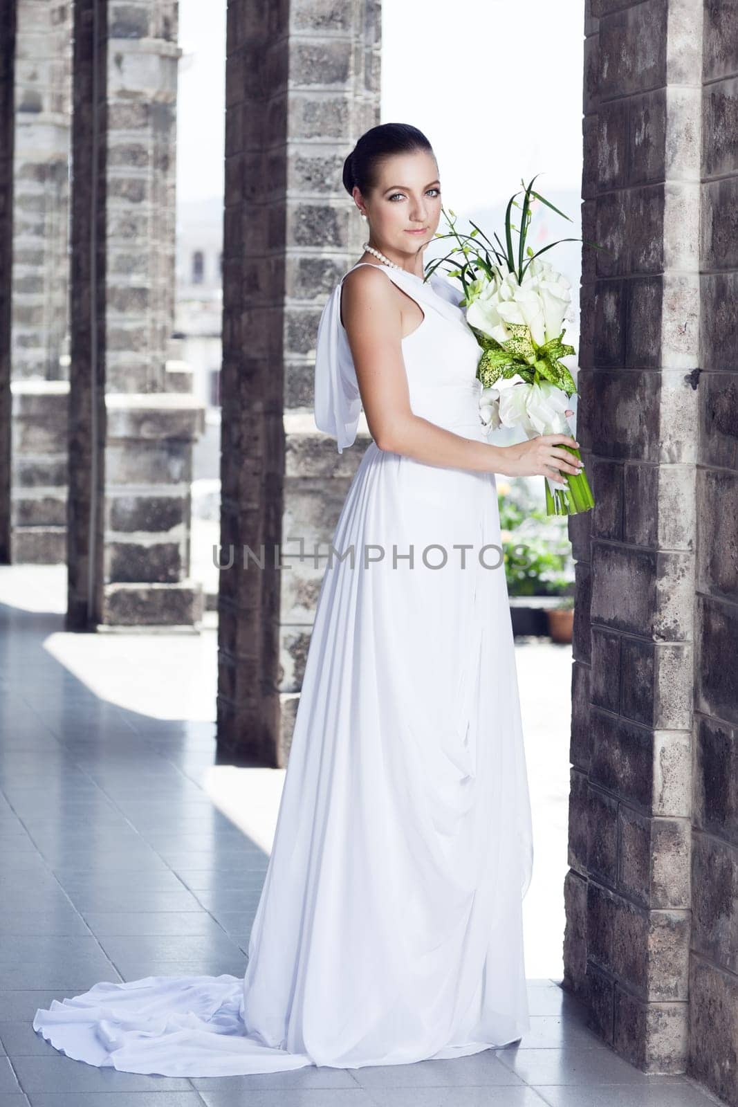Beautiful bride with a wedding bouquet outdoor