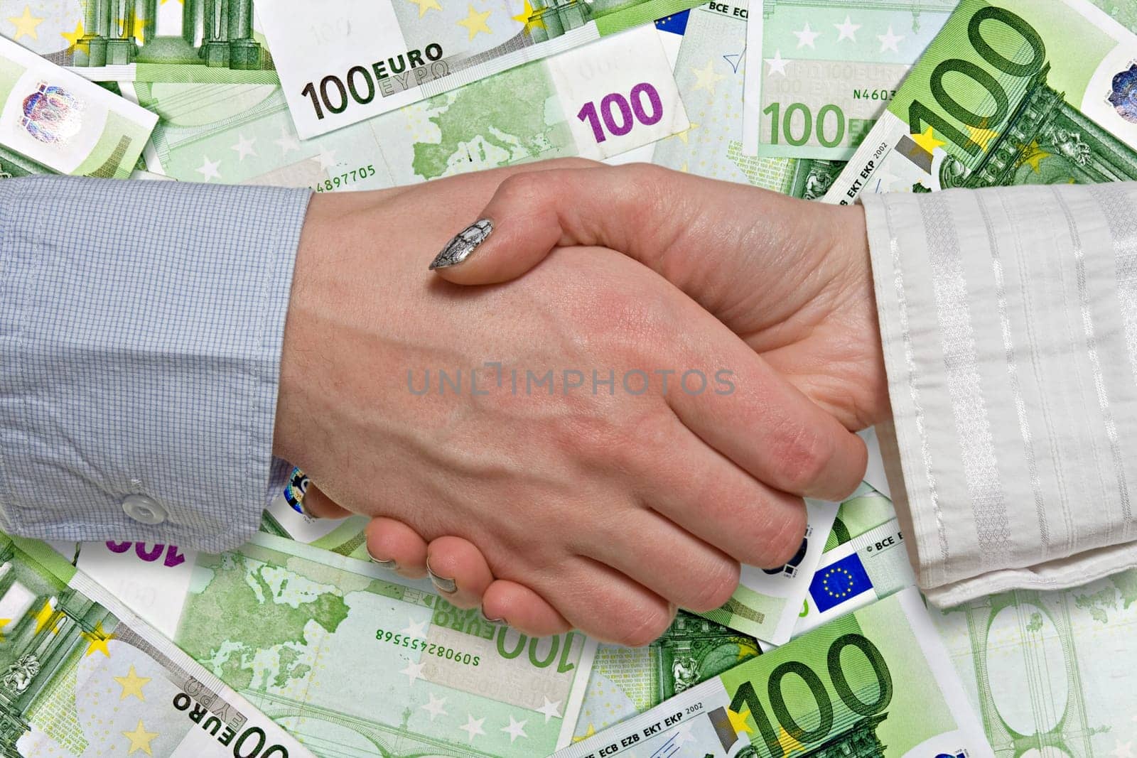 Eurozone deal concept. business handshake on euros background