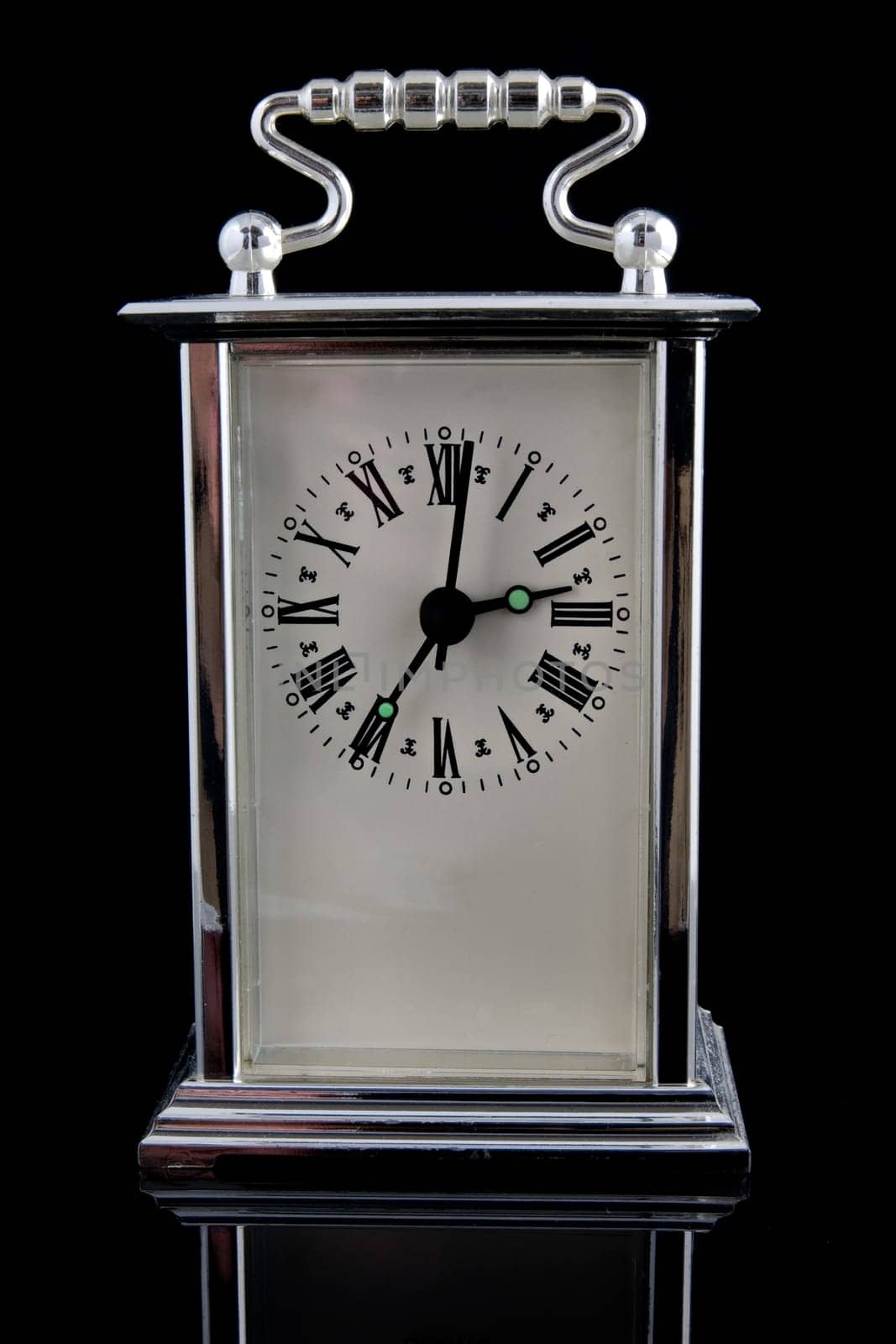 old clock on black background with reflection