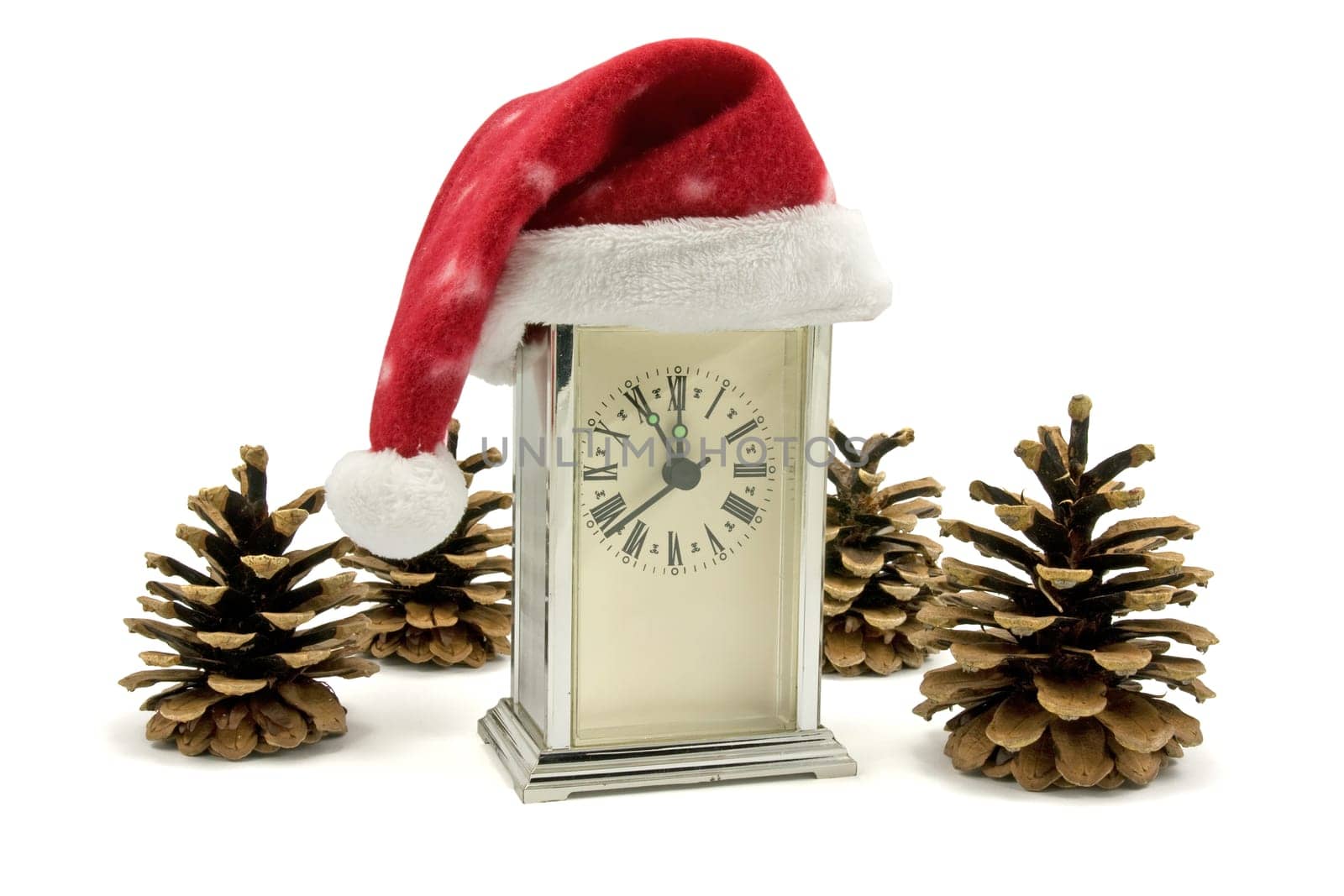 clock with Santa hat and pine cones over white
