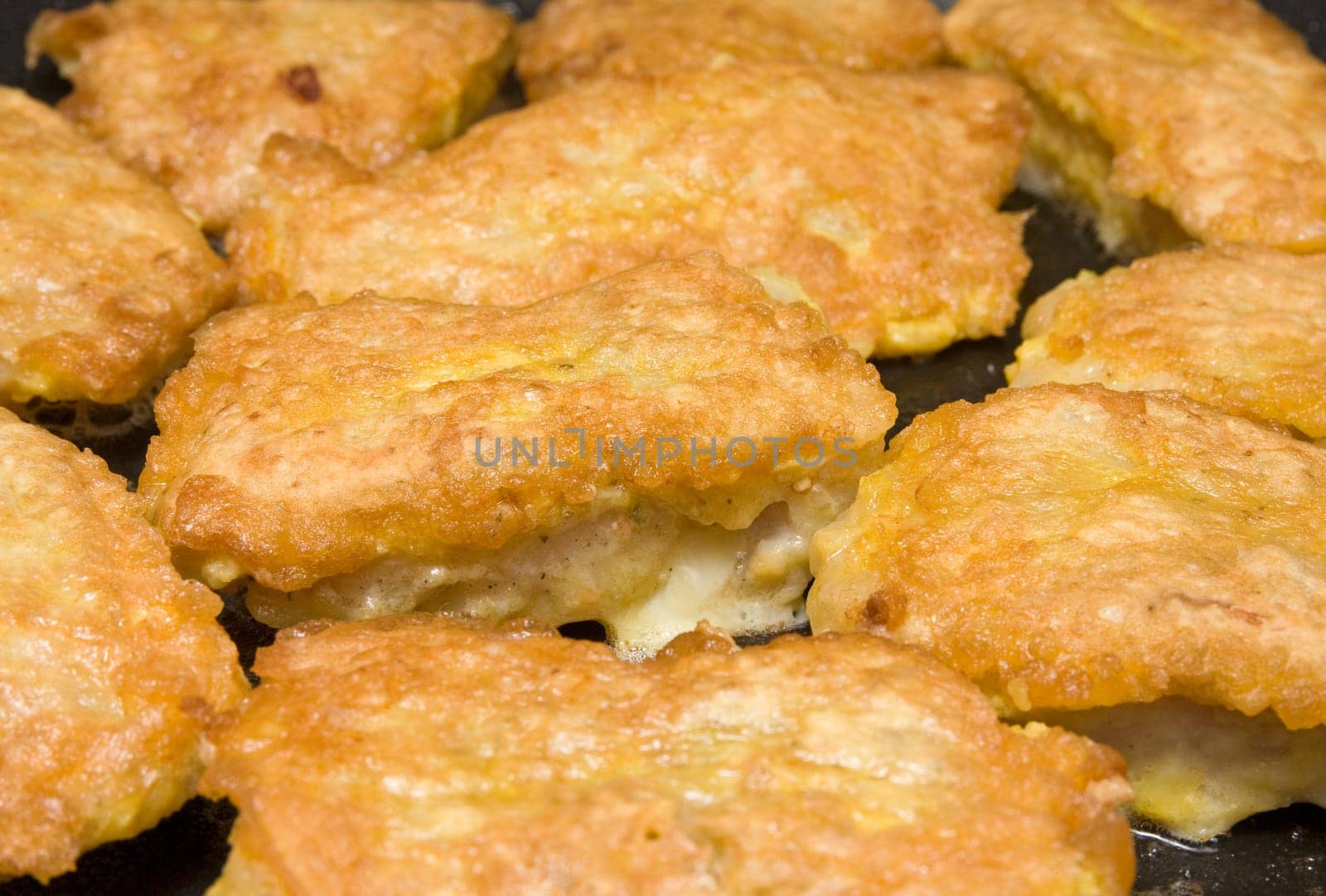 fish fillets roasting in the frying pan