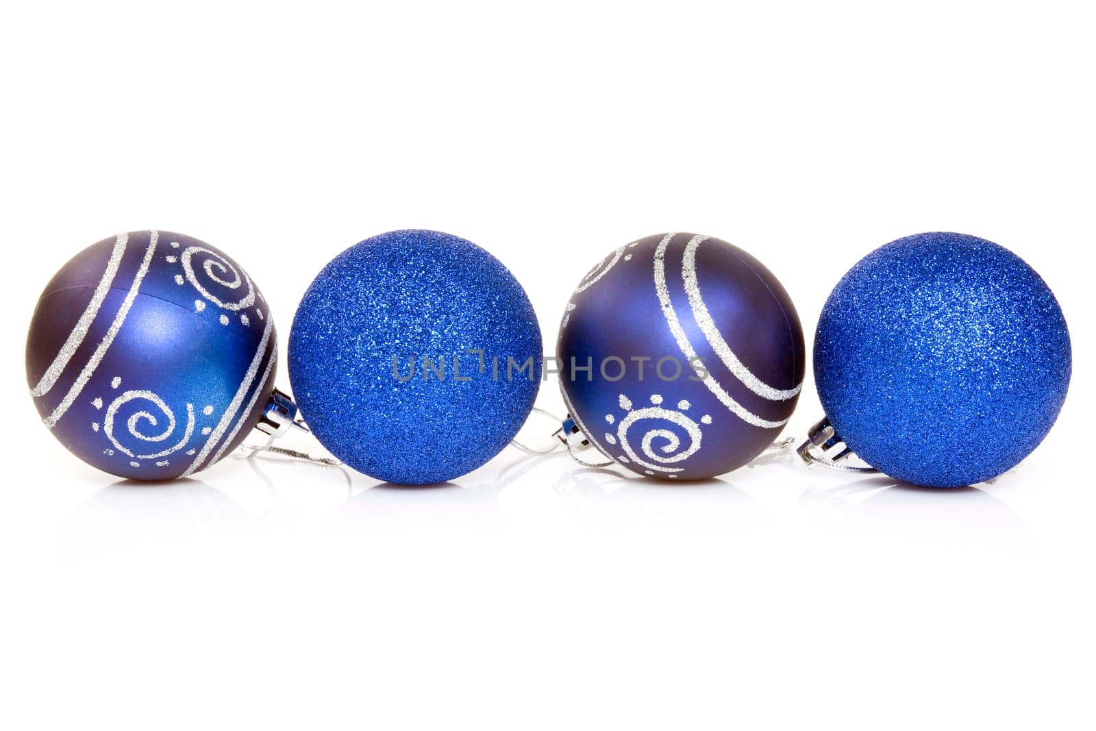 four blue cristmas baubles over a white background.