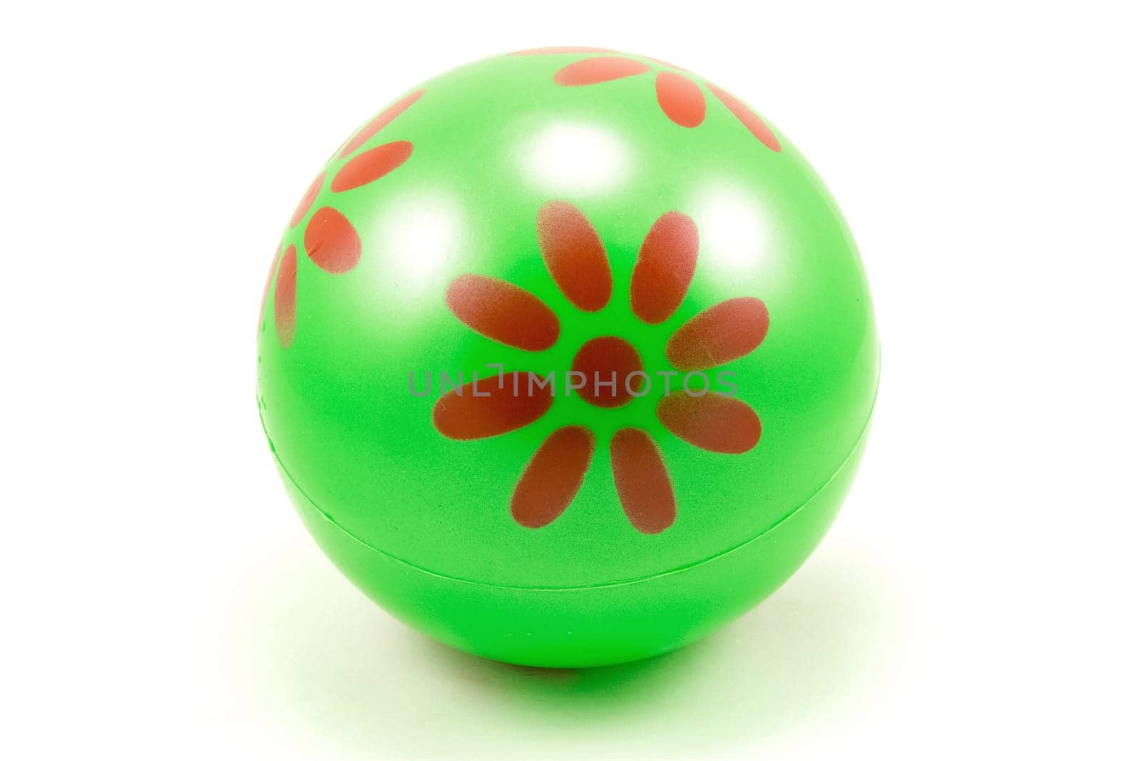 green rubber ball over a white background