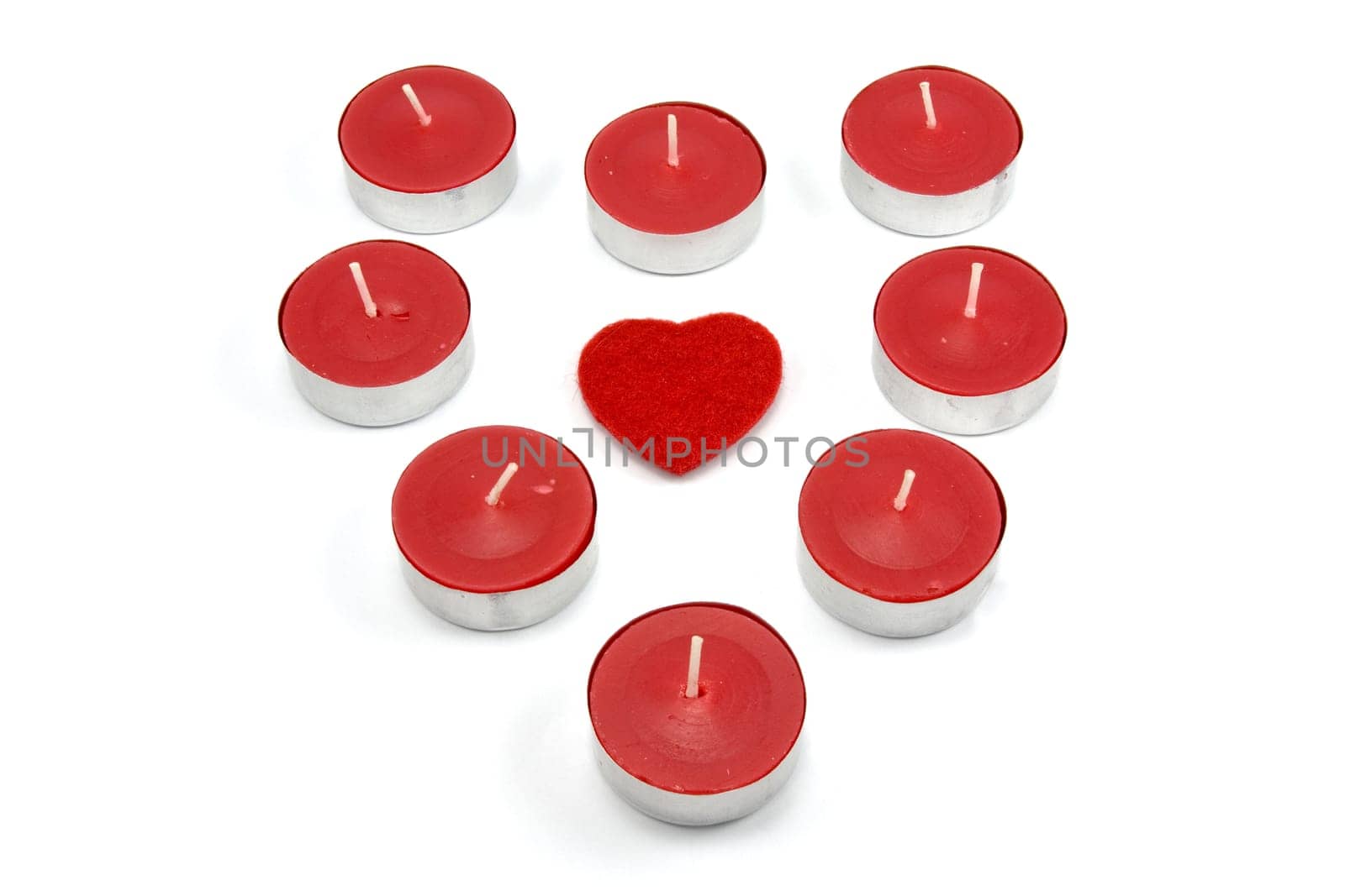 heart shape made from red candles. isolated on white