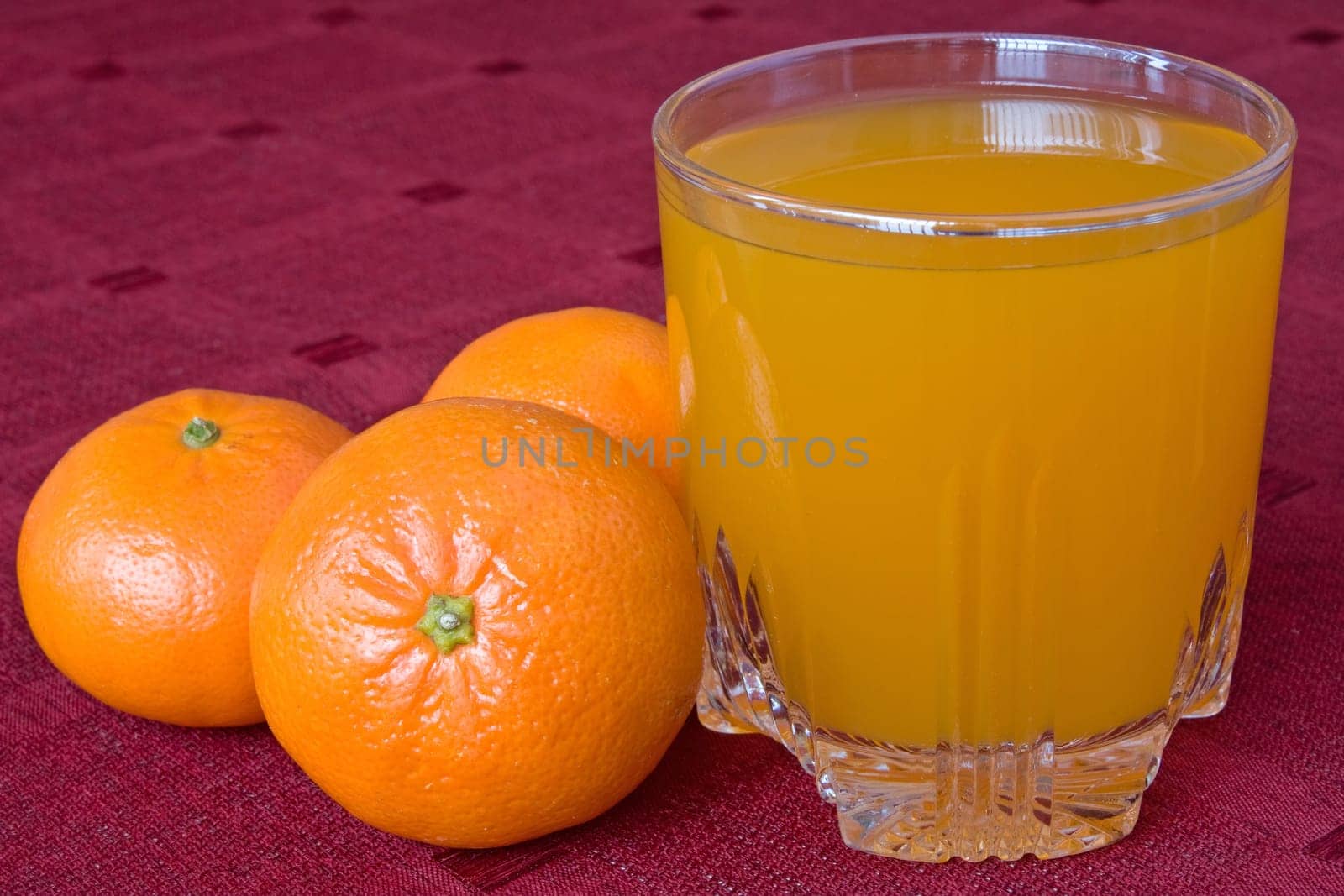 mandarines and glass of juice on the table