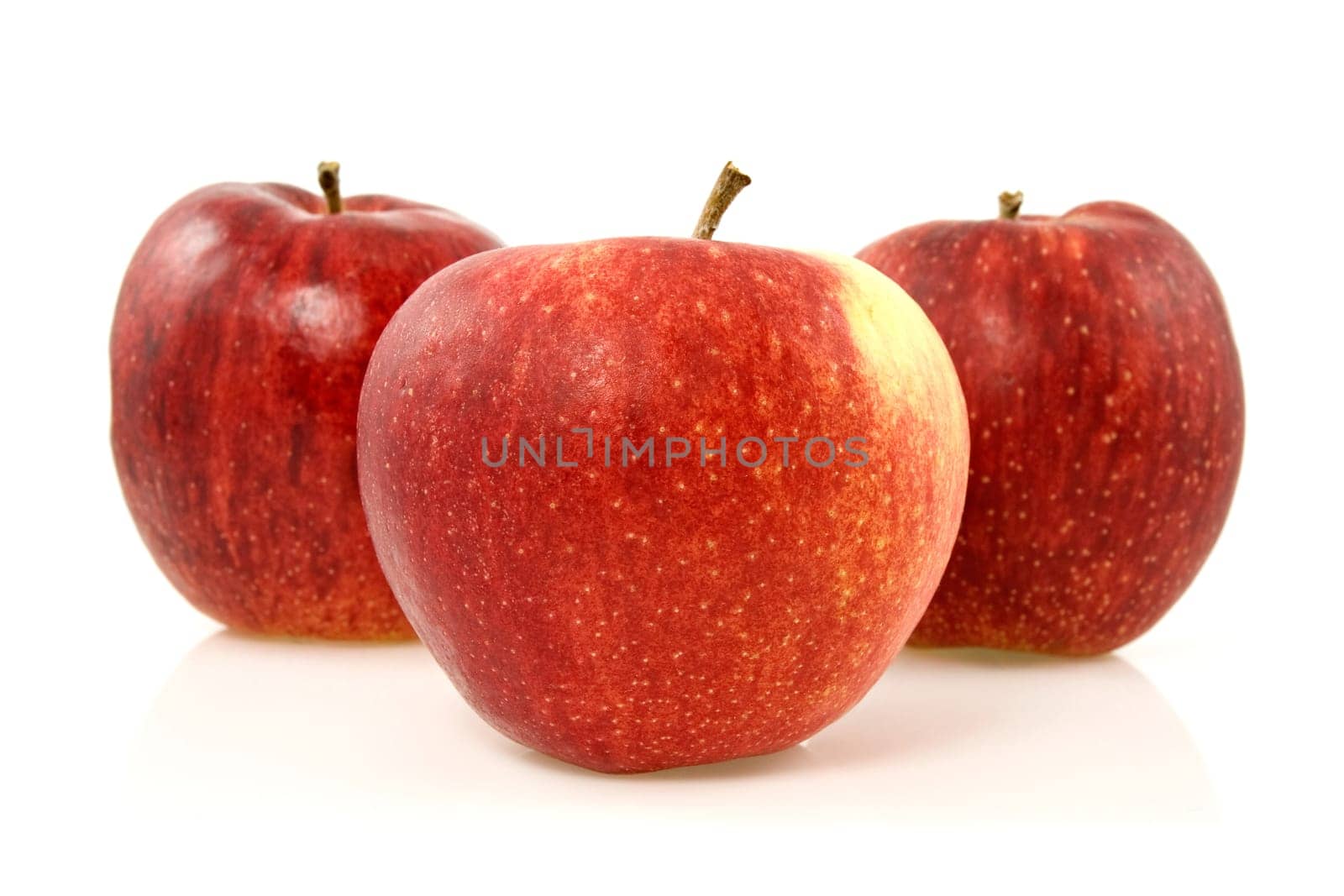 three red apples over a white background