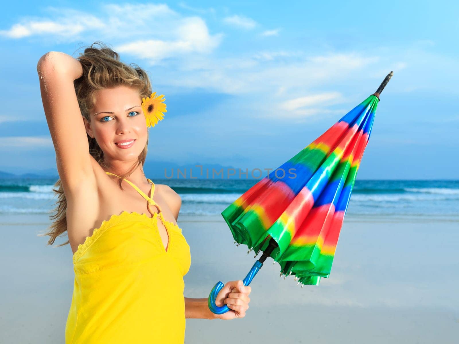 Beautiful woman in yellow dress with umbrella