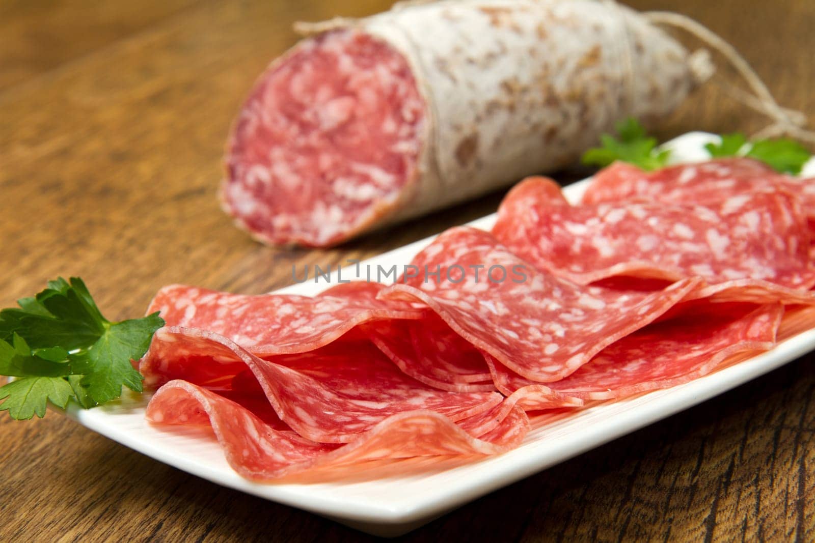 Salami sliced on wood background