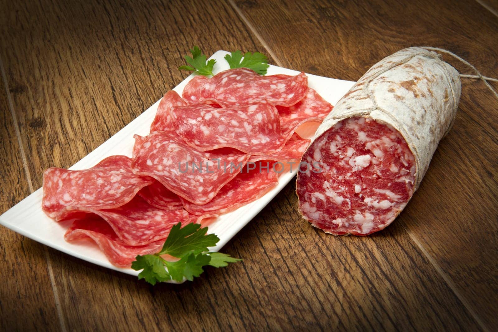 Salami sliced on wood background
