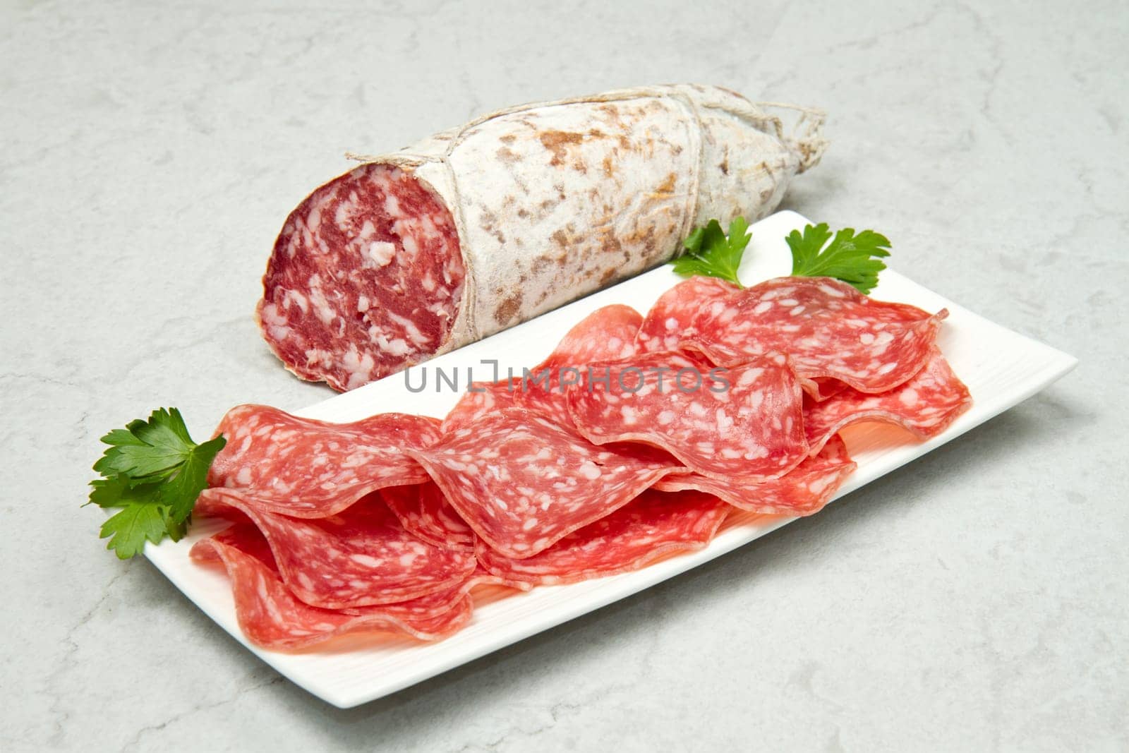 Salami sliced on marble table
