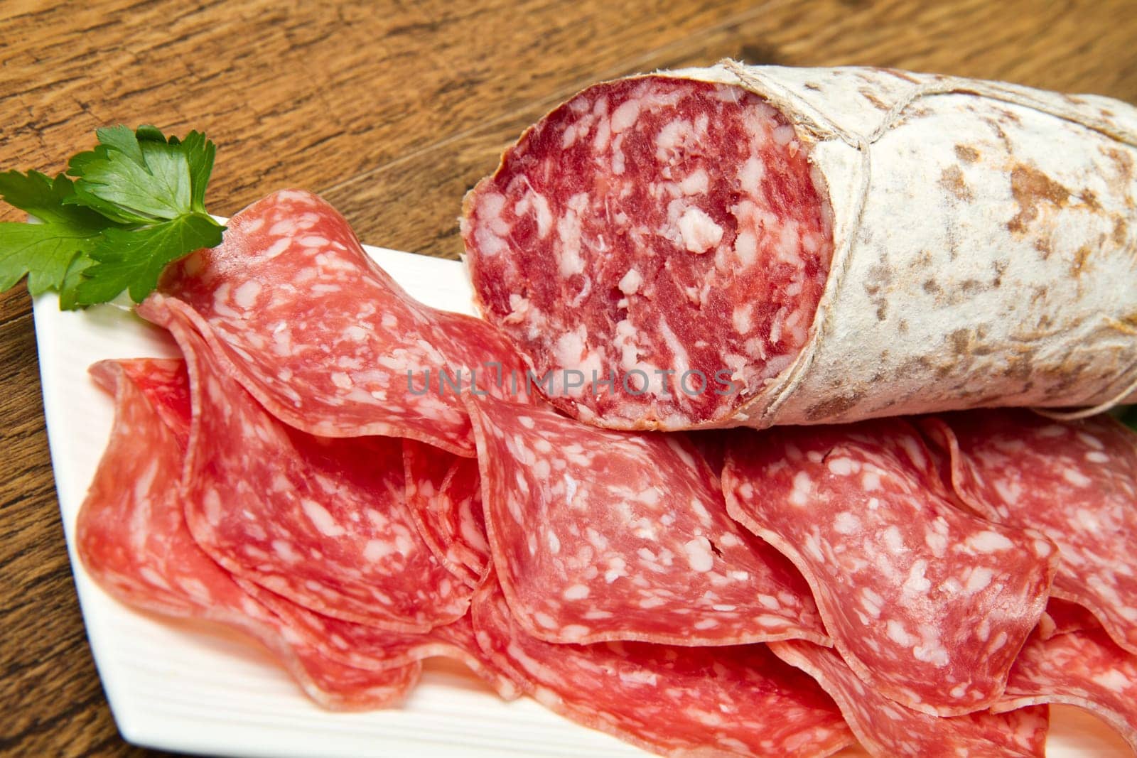 Salami sliced on wood background