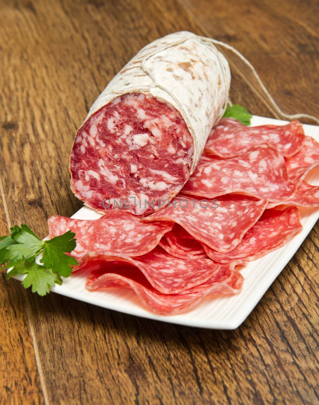 Salami sliced on wood background