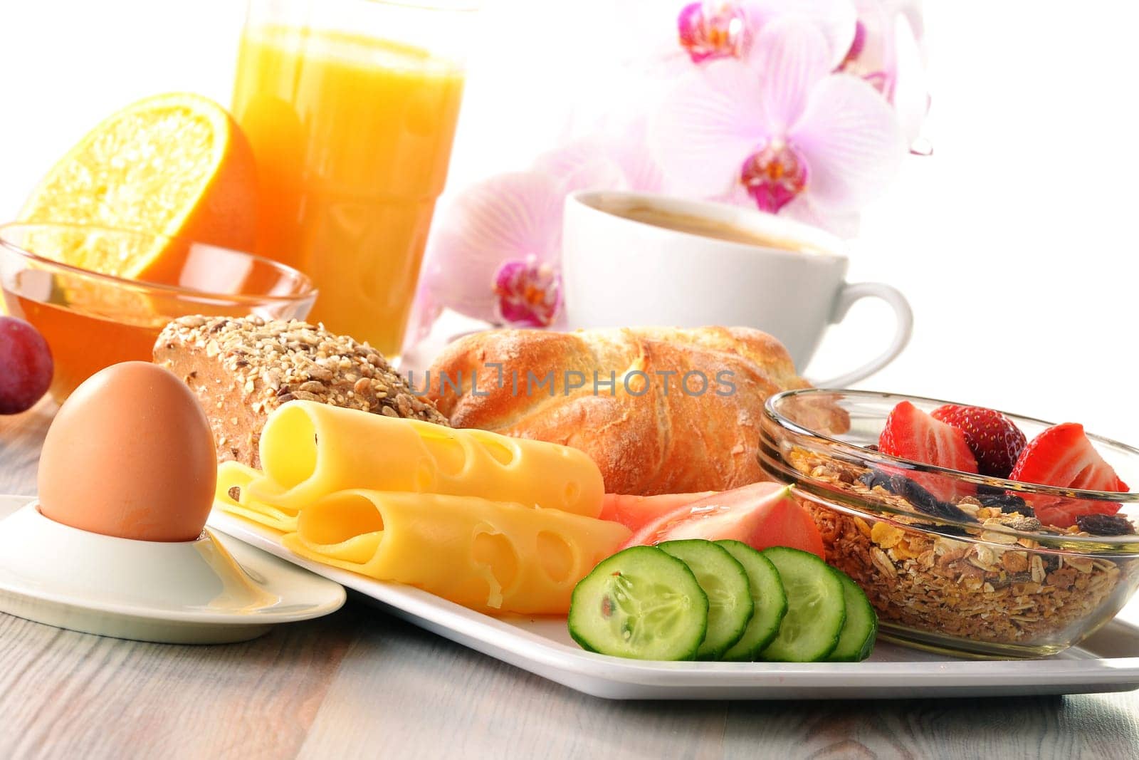 Breakfast with coffee, rolls, egg, orange juice, muesli and cheese