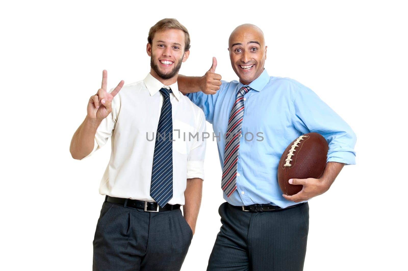 Businessman with rugby ball posing
