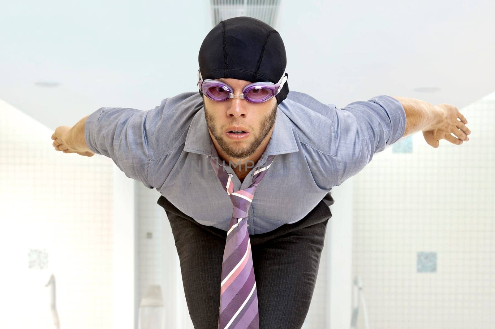Businessman with swimming gear in a pool