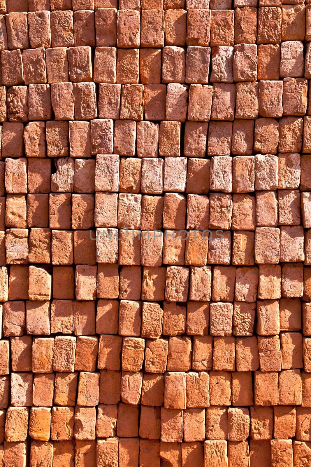 red stapled bricks give a harmonic pattern in the sun
